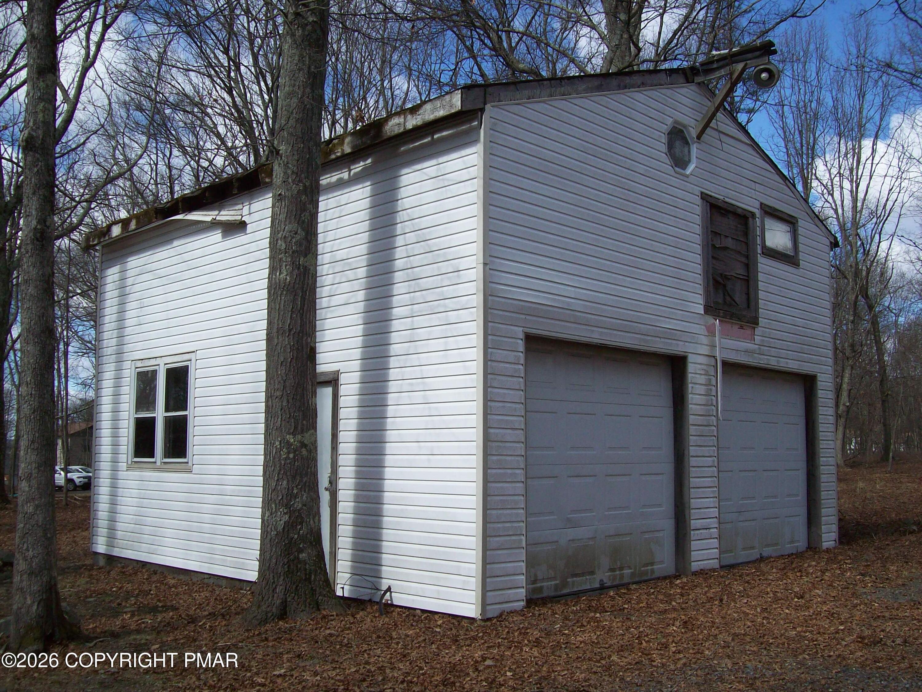 522 Apache Road East Stroudsburg, PA 18302 - Photo 2 of 23 a view of a house with a yard and garage