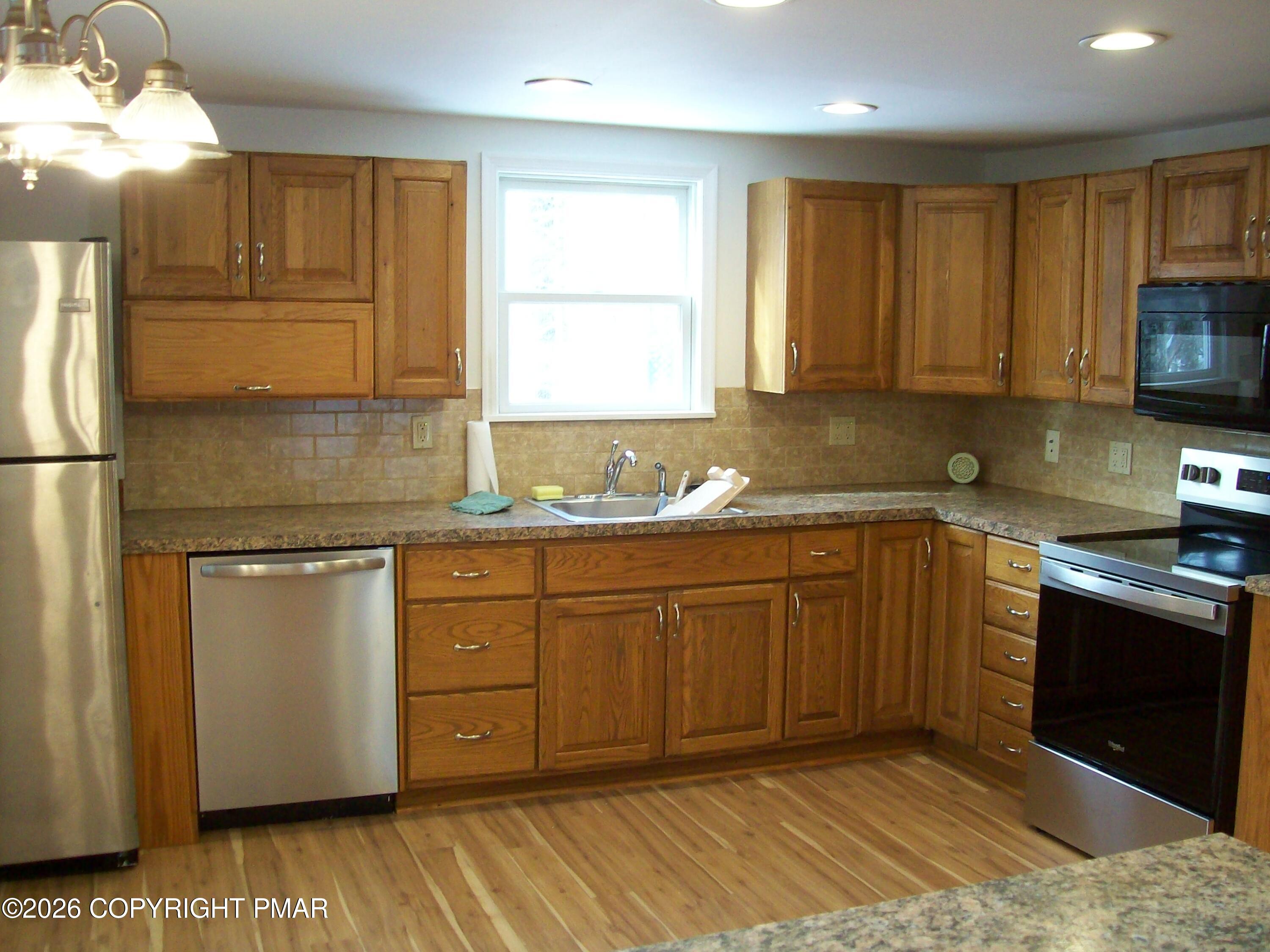 522 Apache Road East Stroudsburg, PA 18302 - Photo 5 of 23 a kitchen with granite countertop cabinets stainless steel appliances a sink and a window