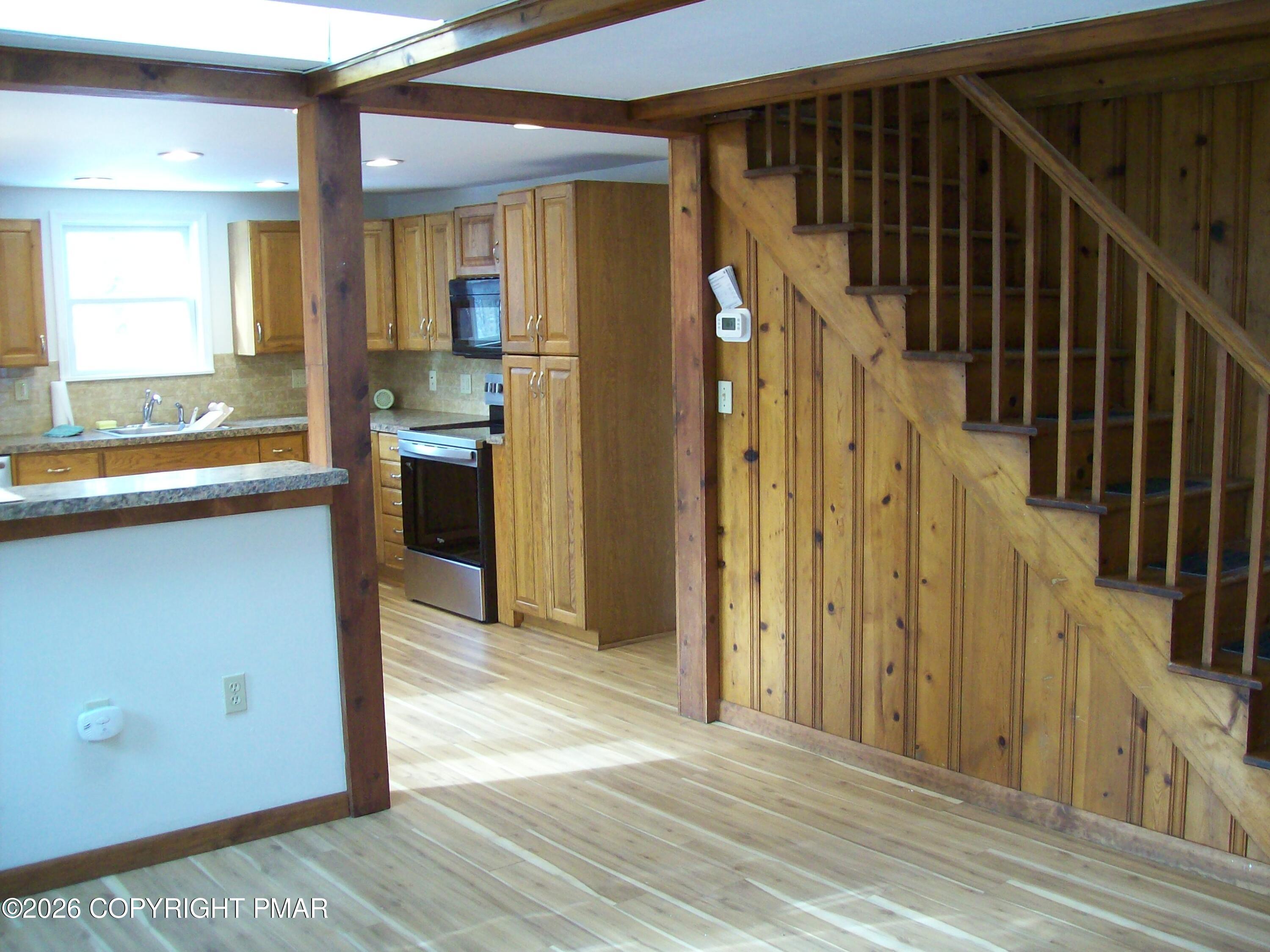 522 Apache Road East Stroudsburg, PA 18302 - Photo 9 of 24 a view of a hallway with wooden floor and staircase