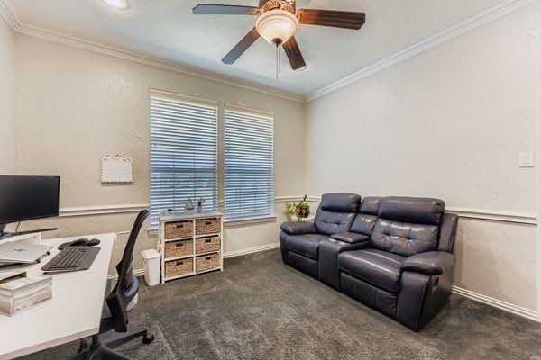 602 Christa Street Ovilla, TX 75154 - Photo 13 of 23 Home office featuring crown molding, dark carpet, ceiling fan, and a textured wall