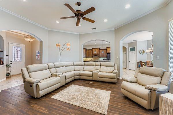 602 Christa Street Ovilla, TX 75154 - Photo 7 of 23 Living area featuring a chandelier, arched walkways, ornamental molding, recessed lighting, and wood finished floors