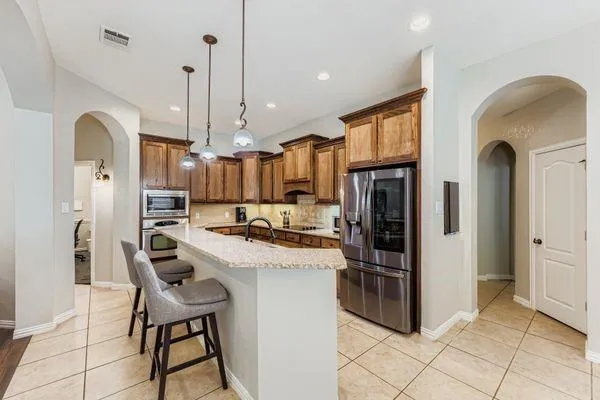 a view of a dining room with furniture and chandelier