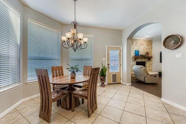 a kitchen with stainless steel appliances kitchen island granite countertop a refrigerator and a sink
