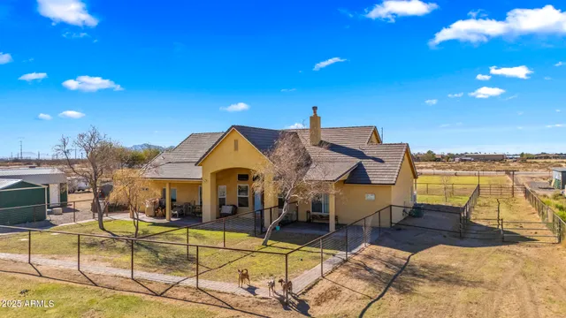 an aerial view of a house with swimming pool outdoor seating