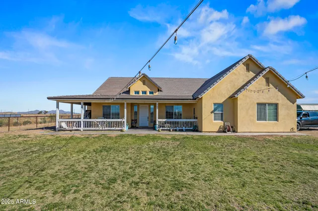 a front view of a house with a garden and deck