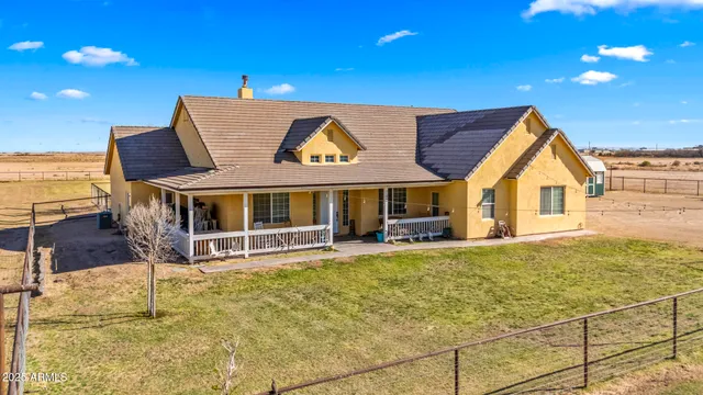 a view of a house with backyard porch and sitting area