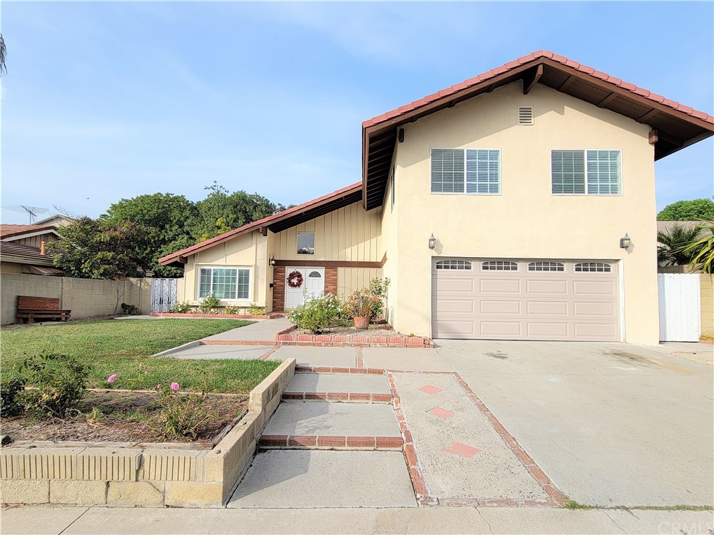 25171 Grissom Road Laguna Hills, CA 92653 - Photo 1 of 1 a front view of a house with a yard and garage
