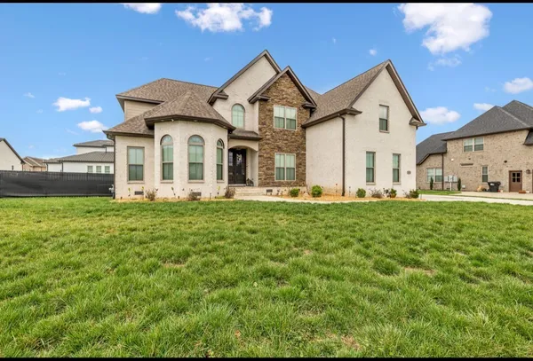 a front view of a house with a yard