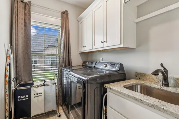 a kitchen with stainless steel appliances granite countertop a sink and a stove