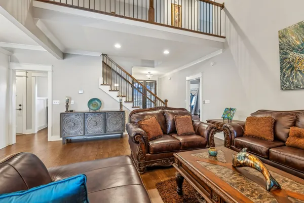 a living room with furniture and a wooden floor