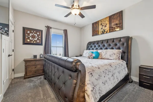 a bedroom with a bed and a chandelier