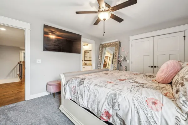 a bedroom with a large bed and a flat screen tv
