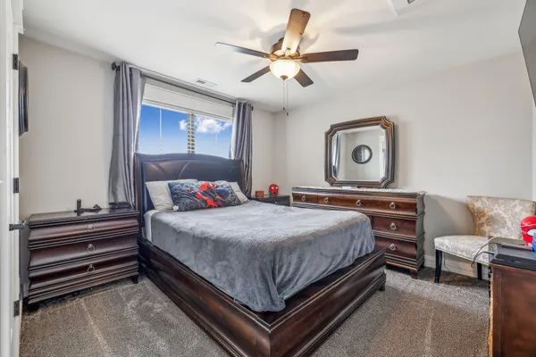 a bedroom with a bed and a chandelier