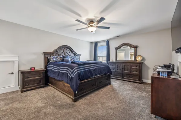 a bedroom with a bed dresser and a window