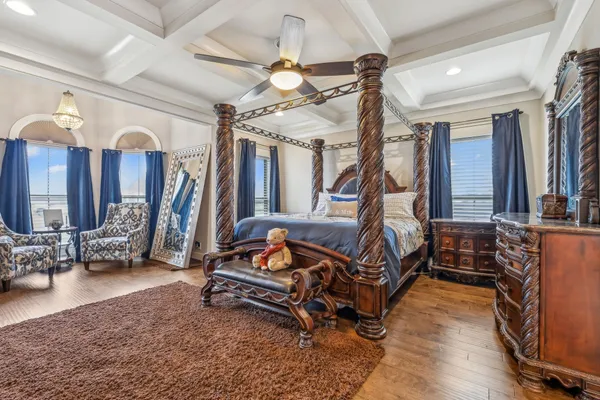 a bedroom with furniture and a flat screen tv
