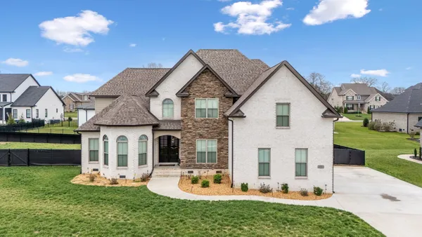 a front view of a house with a garden and patio