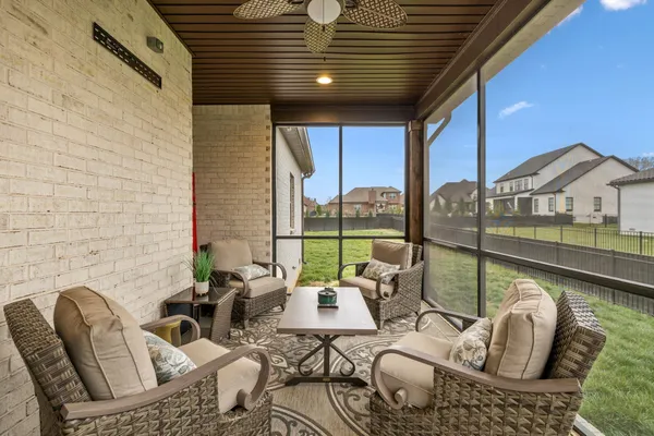 a balcony with furniture and a floor to ceiling window