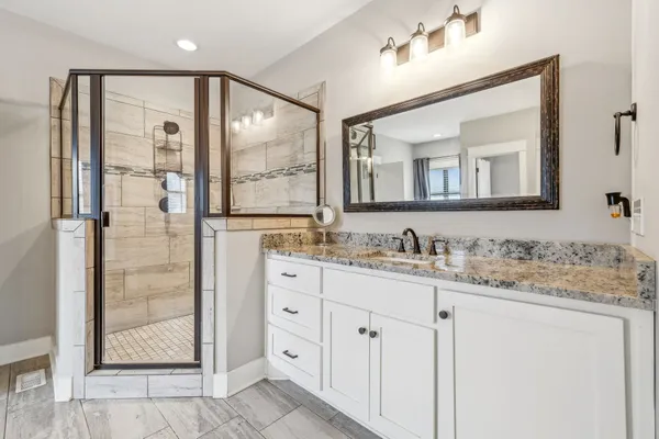 a bathroom with a granite countertop sink mirror and double