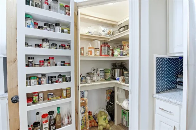a view of a room with furniture and wooden floor