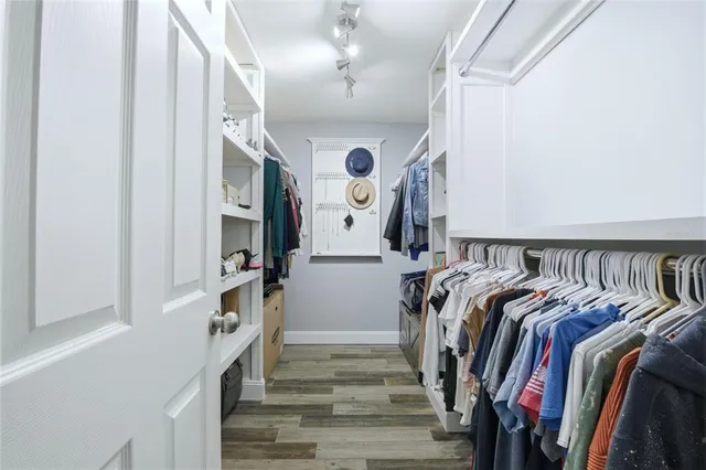a view of a swimming pool with a table and chairs under an umbrella