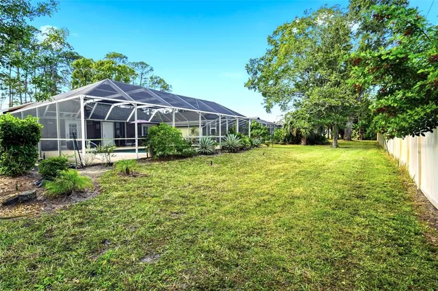 an aerial view of a house with a yard basket ball court and outdoor seating