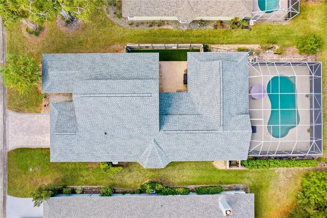 a view of a swimming pool with a fountain and plants