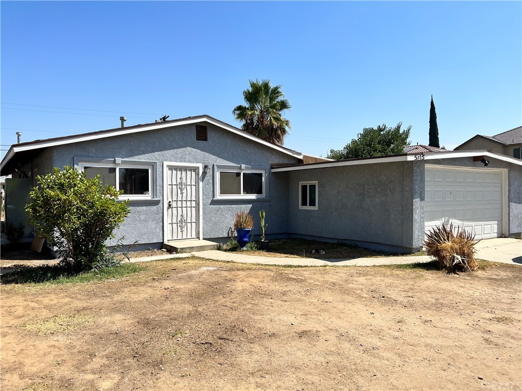 5415 Wayman Street Riverside, CA 92504 - Photo 1 of 1 a backyard of a house with potted plants and trees