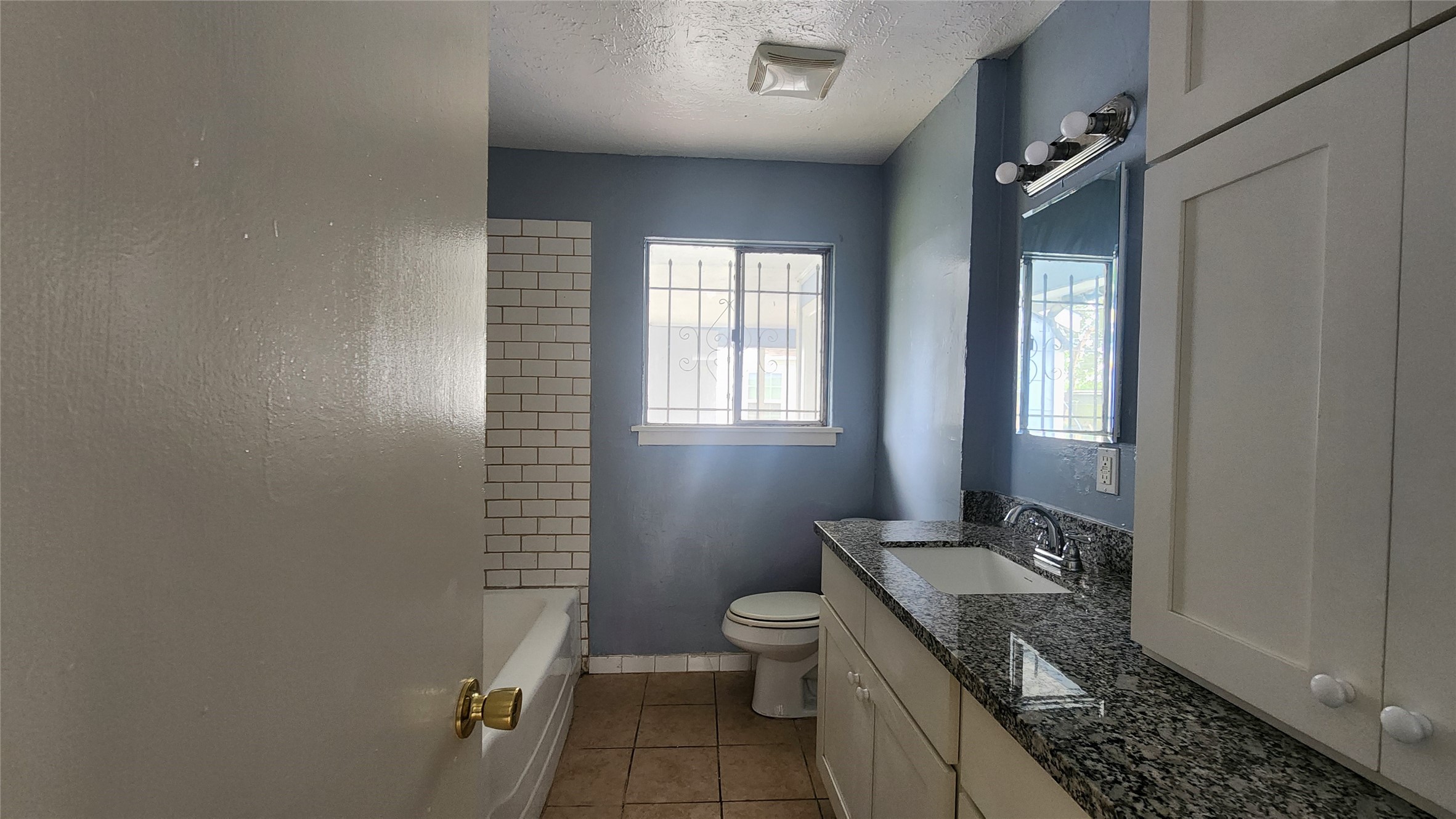 6114 Hartwick Road Houston, TX 77016 - Photo 12 of 14 a bathroom with a granite countertop sink toilet and shower