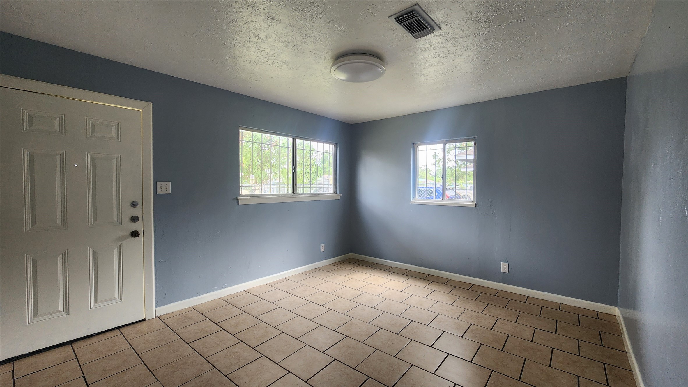 6114 Hartwick Road Houston, TX 77016 - Photo 3 of 14 wooden floor in an empty room with a window