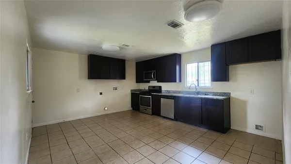 a large kitchen with cabinets