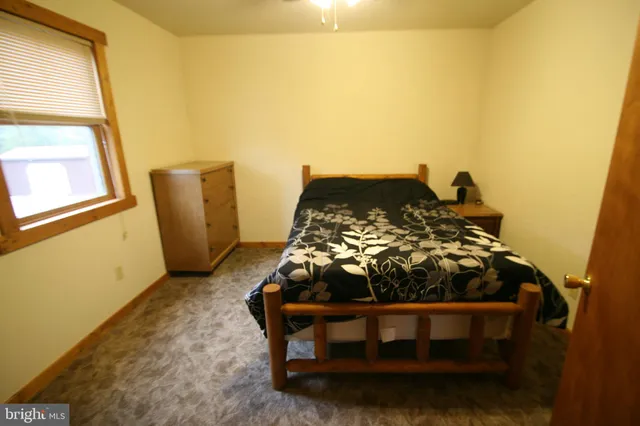 a bed sitting in a bedroom next to a window