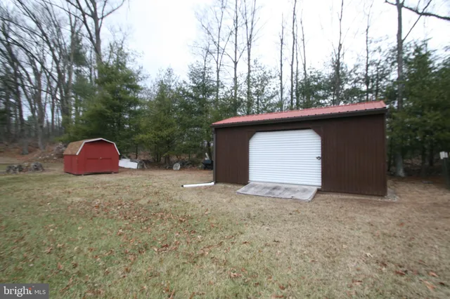 a view of a wooden house with a yard