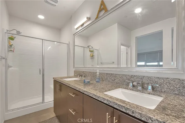 a kitchen with stainless steel appliances granite countertop a sink and a refrigerator