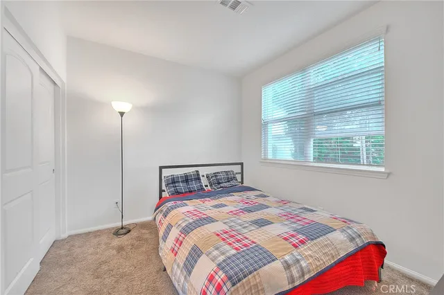 a bedroom with a bed and a bookshelf