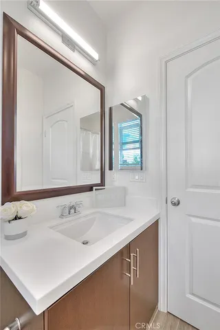 a bathroom with a sink a toilet and a mirror
