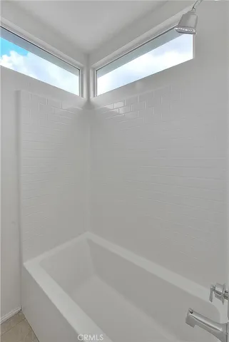 a view of a balcony with chair and wooden floor