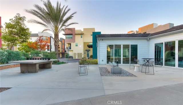 a patio with yard glass top table and chairs