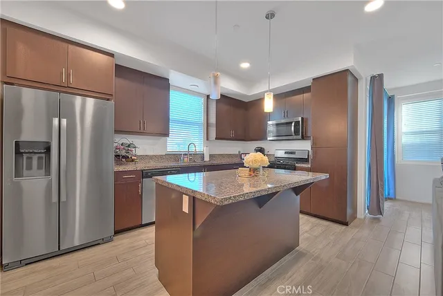 a kitchen with stainless steel appliances granite countertop a sink and a microwave
