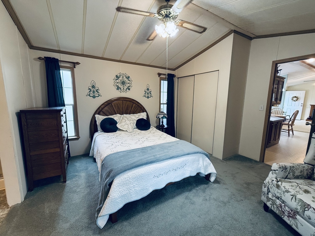 268 Palmer Road, Unit 44 Monson, MA 01057 - Photo 13 of 34 a bedroom with a bed and a chandelier