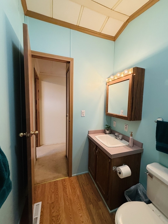 268 Palmer Road, Unit 44 Monson, MA 01057 - Photo 25 of 34 a bathroom with a toilet sink vanity and mirror