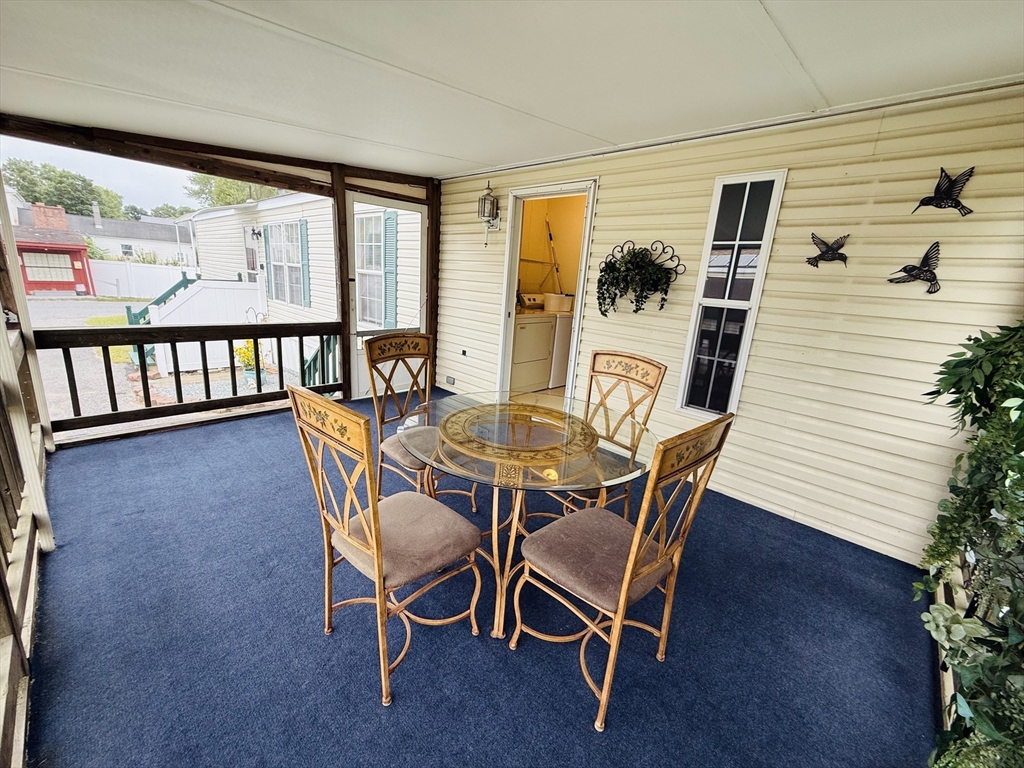 268 Palmer Road, Unit 44 Monson, MA 01057 - Photo 27 of 34 a dining room with furniture and large windows