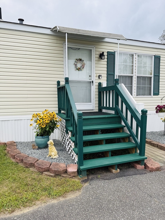 268 Palmer Road, Unit 44 Monson, MA 01057 - Photo 29 of 34 a front view of a house with a yard