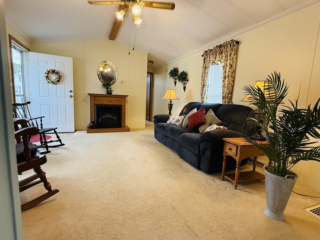 268 Palmer Road, Unit 44 Monson, MA 01057 - Photo 3 of 34 a living room with furniture and a fireplace
