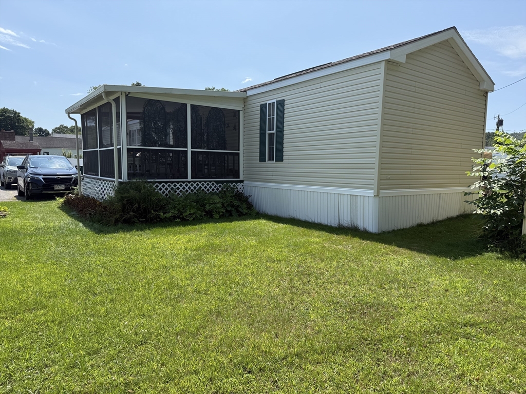 268 Palmer Road, Unit 44 Monson, MA 01057 - Photo 31 of 34 a view of a backyard with potted plants and large trees