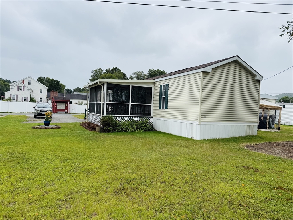 268 Palmer Road, Unit 44 Monson, MA 01057 - Photo 32 of 34 a view of a house with backyard and sitting area