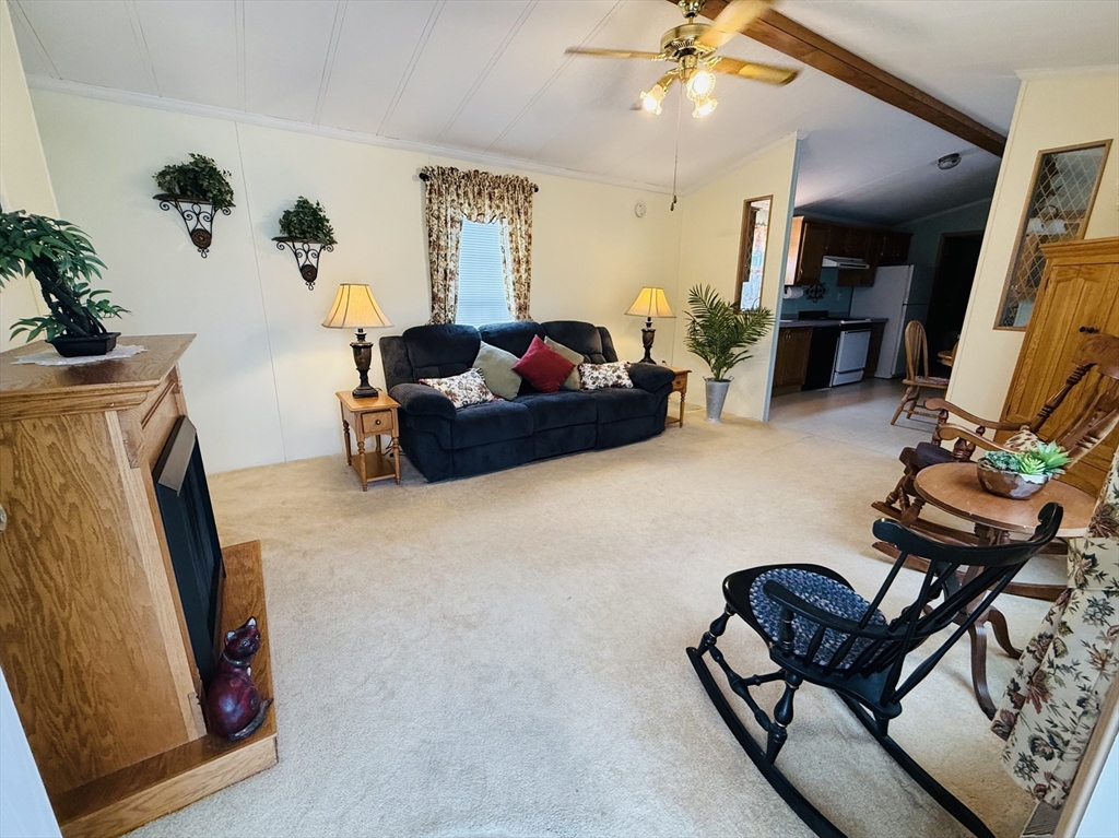 268 Palmer Road, Unit 44 Monson, MA 01057 - Photo 6 of 34 a living room with furniture and a flat screen tv