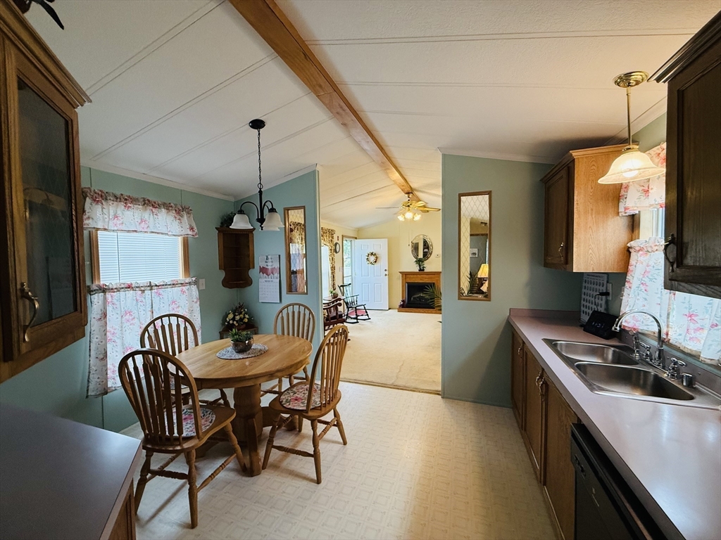 268 Palmer Road, Unit 44 Monson, MA 01057 - Photo 8 of 34 a dining room with furniture and a chandelier