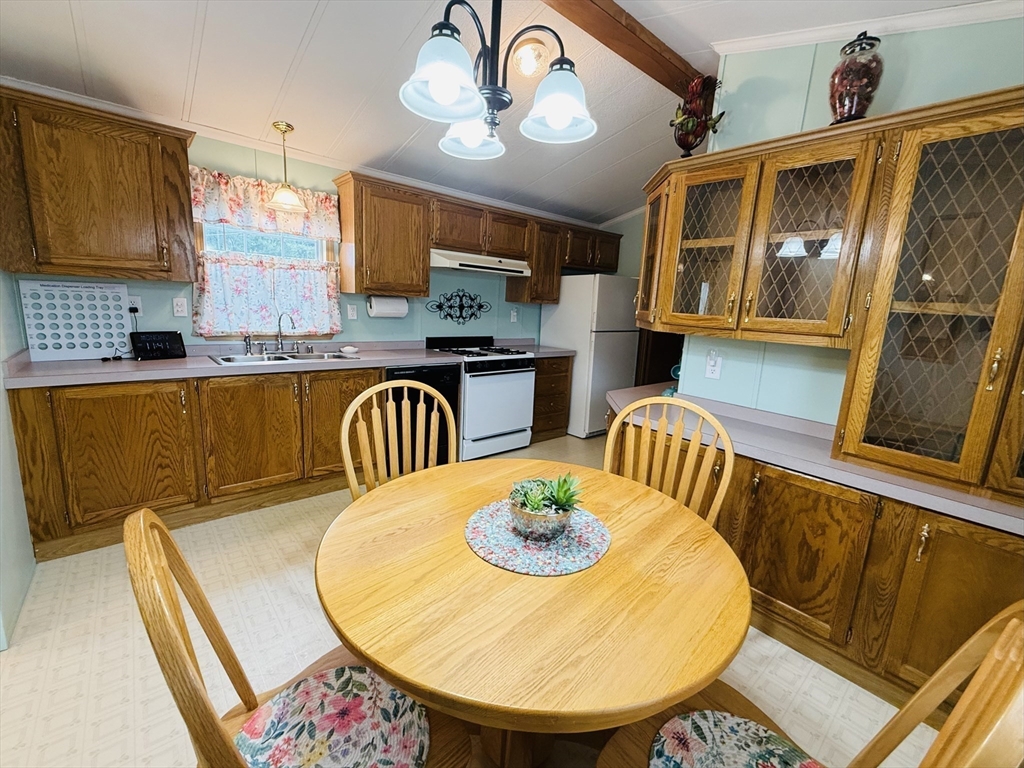 268 Palmer Road, Unit 44 Monson, MA 01057 - Photo 9 of 34 a view of a dining room with furniture a chandelier and wooden floor