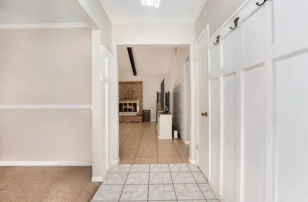 a view of a hallway with a livingroom and a bathroom with bathtub