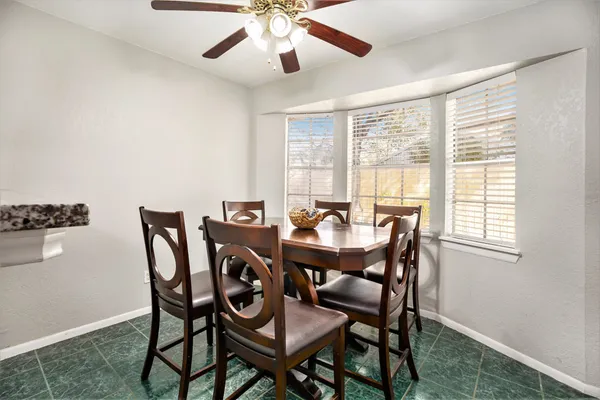 a view of a dining room with furniture and a window